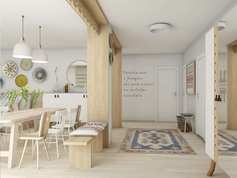 Holul casei este separat de living prin 2 porti metaforice decorate cu panouri traforate, ca cele de la streasinile casei.