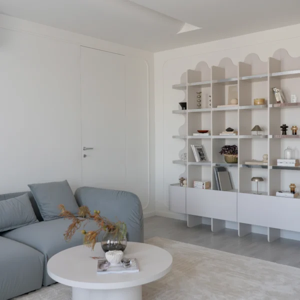 design interior living cu biblioteca inedita cu contur ondulat si cant de tip oglinda si canapea Mille bleu teal